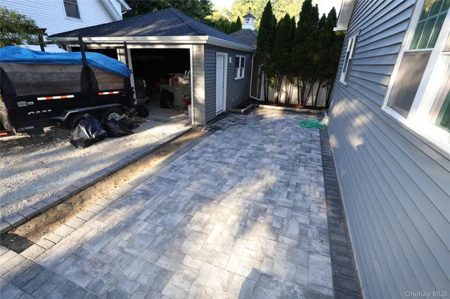 a view of house with yard and furniture