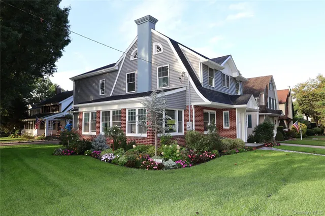 a front view of a house with a garden