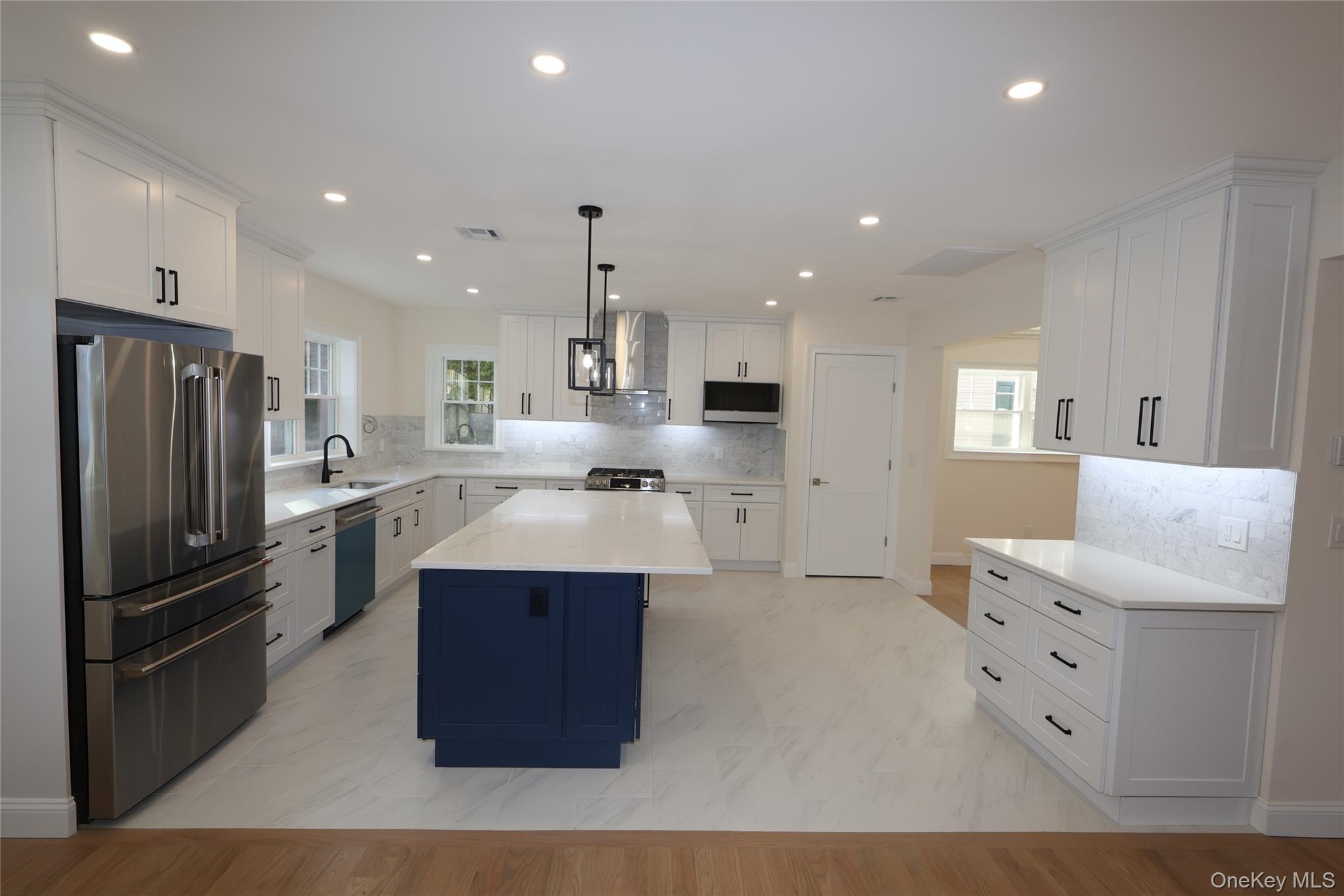 78 Ontario Road Floral Park, NY 11001 - Photo 3 of 38 a kitchen with stainless steel appliances kitchen island granite countertop a refrigerator and a sink