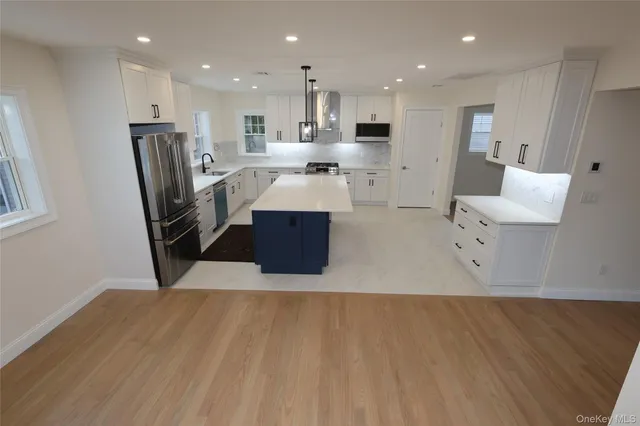 a large room with wooden floor and windows