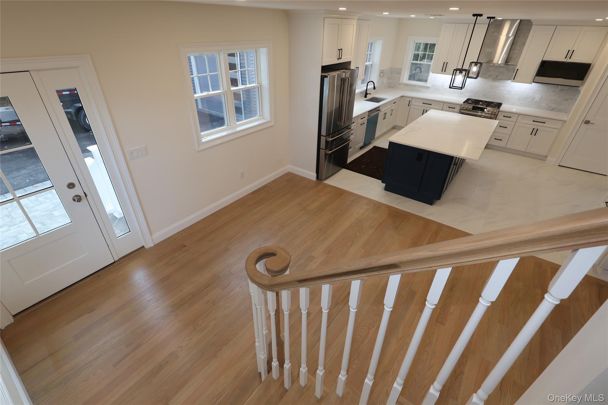 78 Ontario Road Floral Park, NY 11001 - Photo 9 of 38 a kitchen with stainless steel appliances a refrigerator a sink a stove and white cabinets