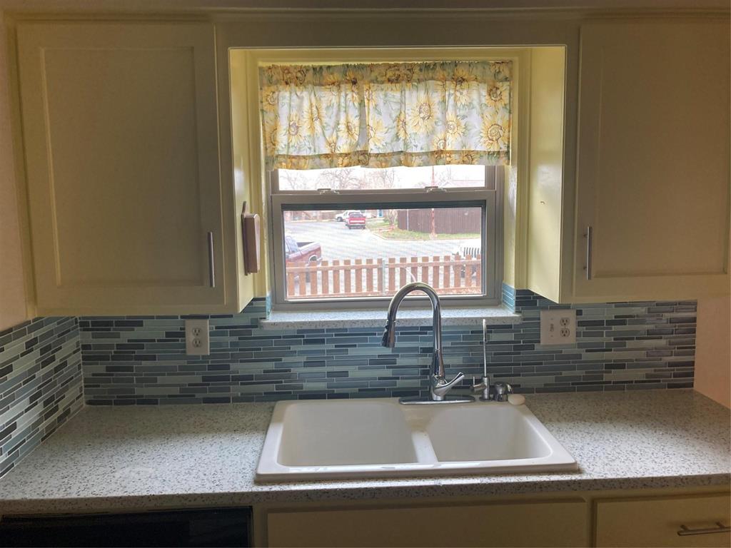 a kitchen with a sink and a window