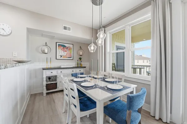 a view of a dining room with furniture window and wooden floor