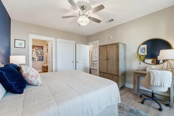 a bedroom with a bed gym equipment and a chandelier