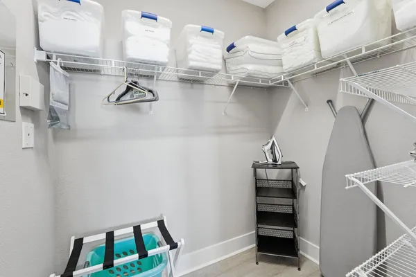 a view of walk in closet with clothes and shoes
