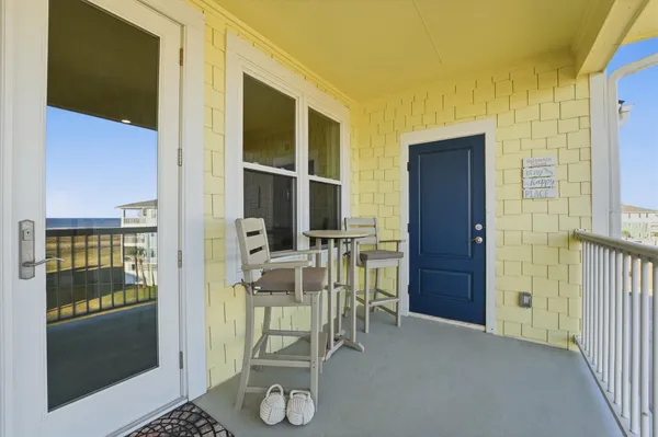 a dining room with furniture and front door