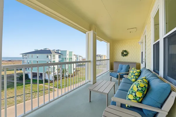 a view of a living room with furniture and a large window