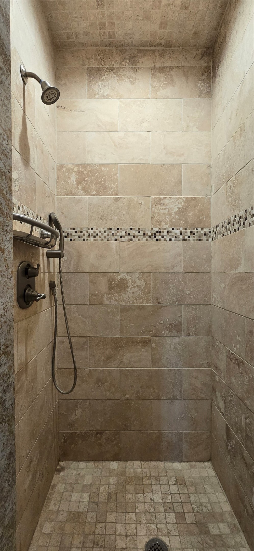1117 Bonner Street Houston, TX 77007 - Photo 37 of 44 The primary bathroom walk-in shower includes brushed nickel fixtures, neutral color tiles and beautiful mosaic tiling for extra detail.