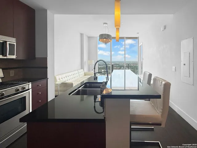 a kitchen with a sink a stove and a microwave