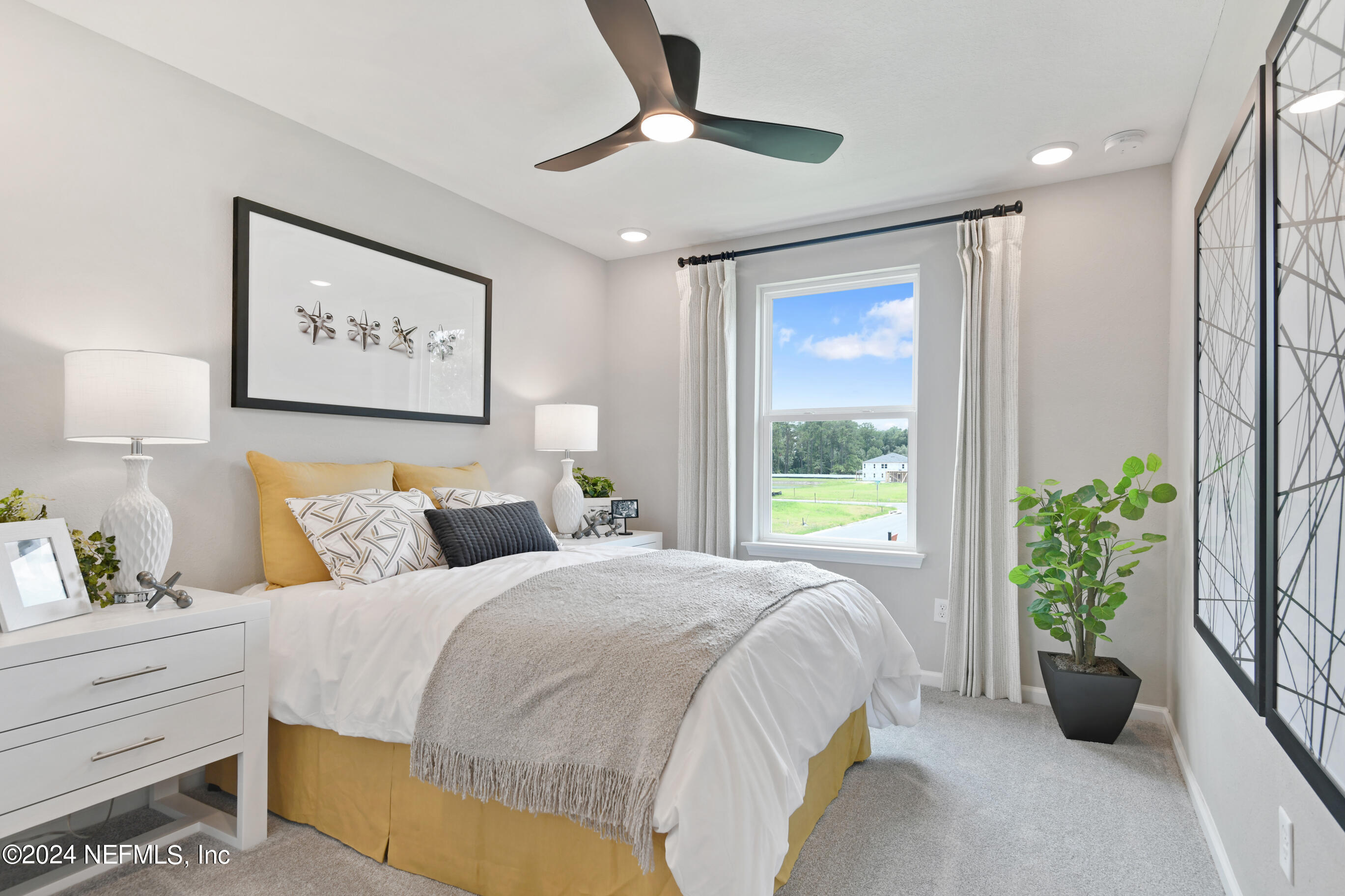 6858 Rhapsody Road Jacksonville, FL 32244 - Photo 17 of 20 a bedroom with a bed and a potted plant