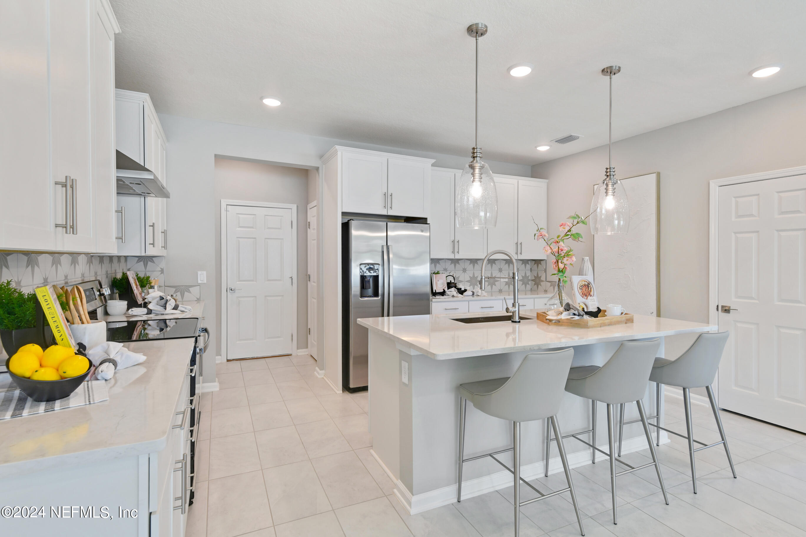 6858 Rhapsody Road Jacksonville, FL 32244 - Photo 5 of 20 a kitchen with refrigerator and chairs