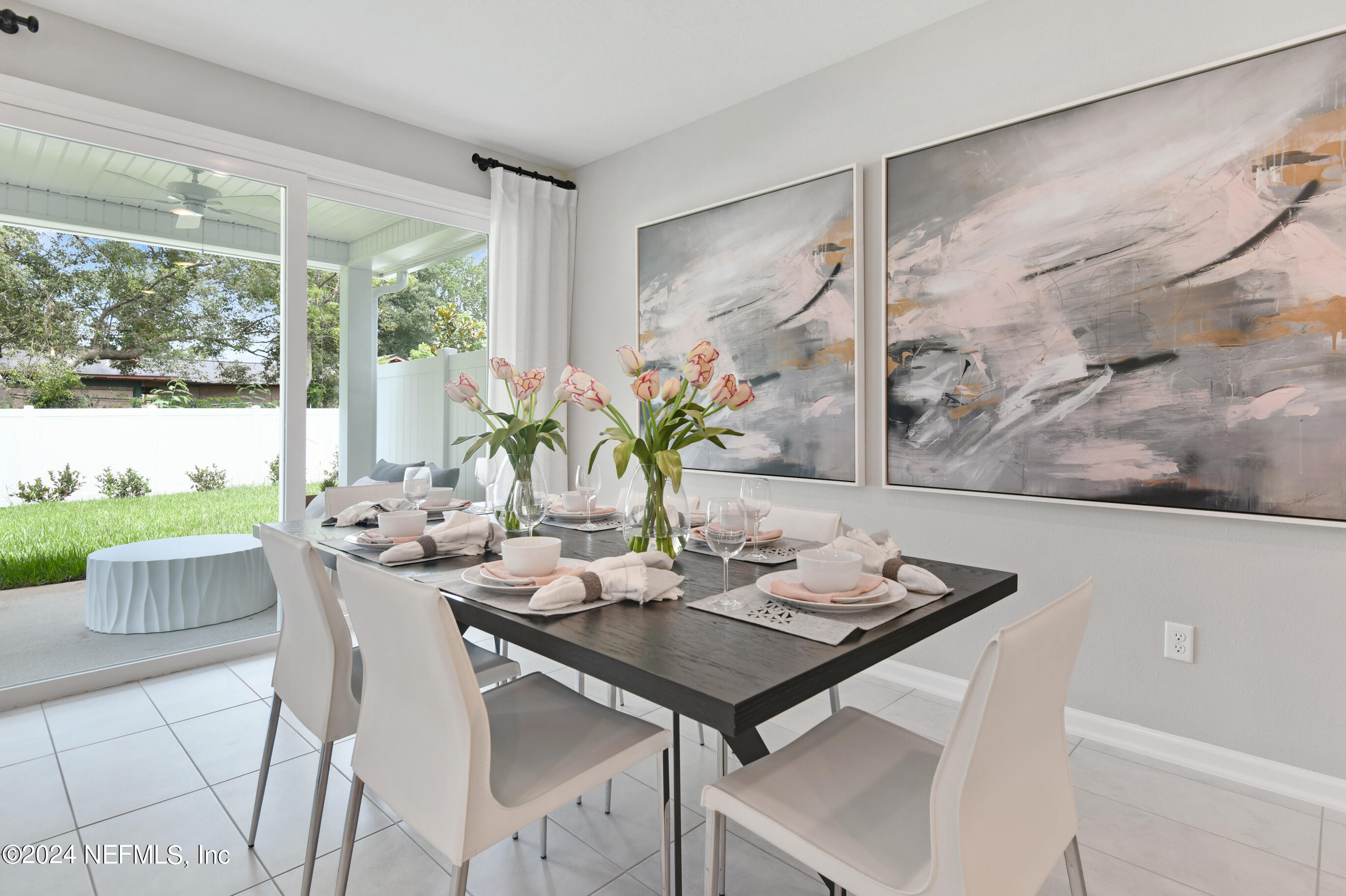 6858 Rhapsody Road Jacksonville, FL 32244 - Photo 8 of 20 a view of a dining room with furniture large windows and wooden floor