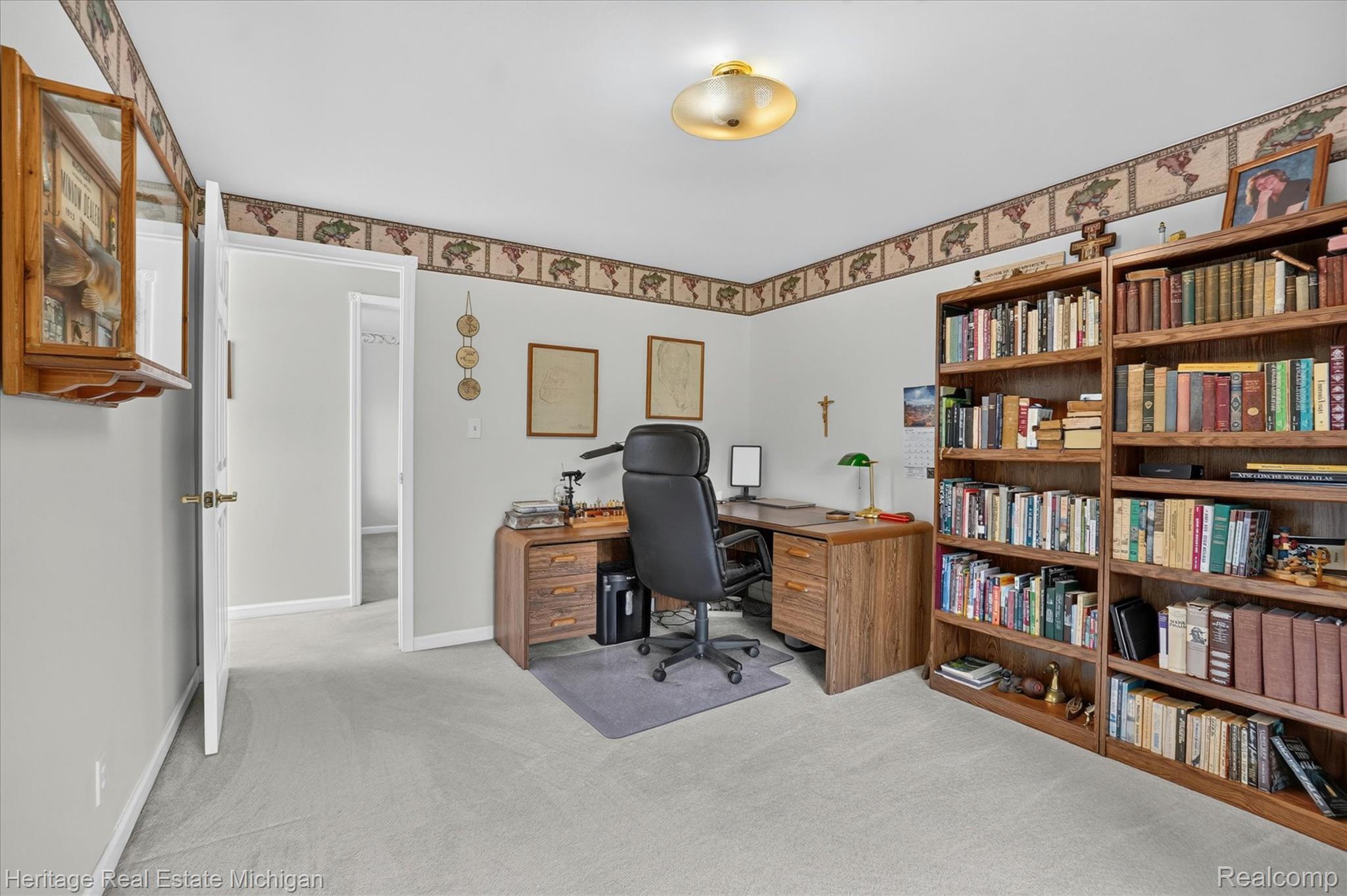 14038 North Hogan Road Linden, MI 48451 - Photo 10 of 53 Interior room featuring light gray wall paint, carpeting, and a decorative wallpaper border