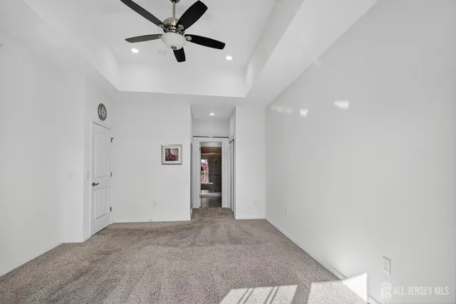 a view of an empty room and a ceiling fan