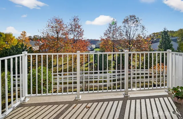 a view of a balcony with wooden floor