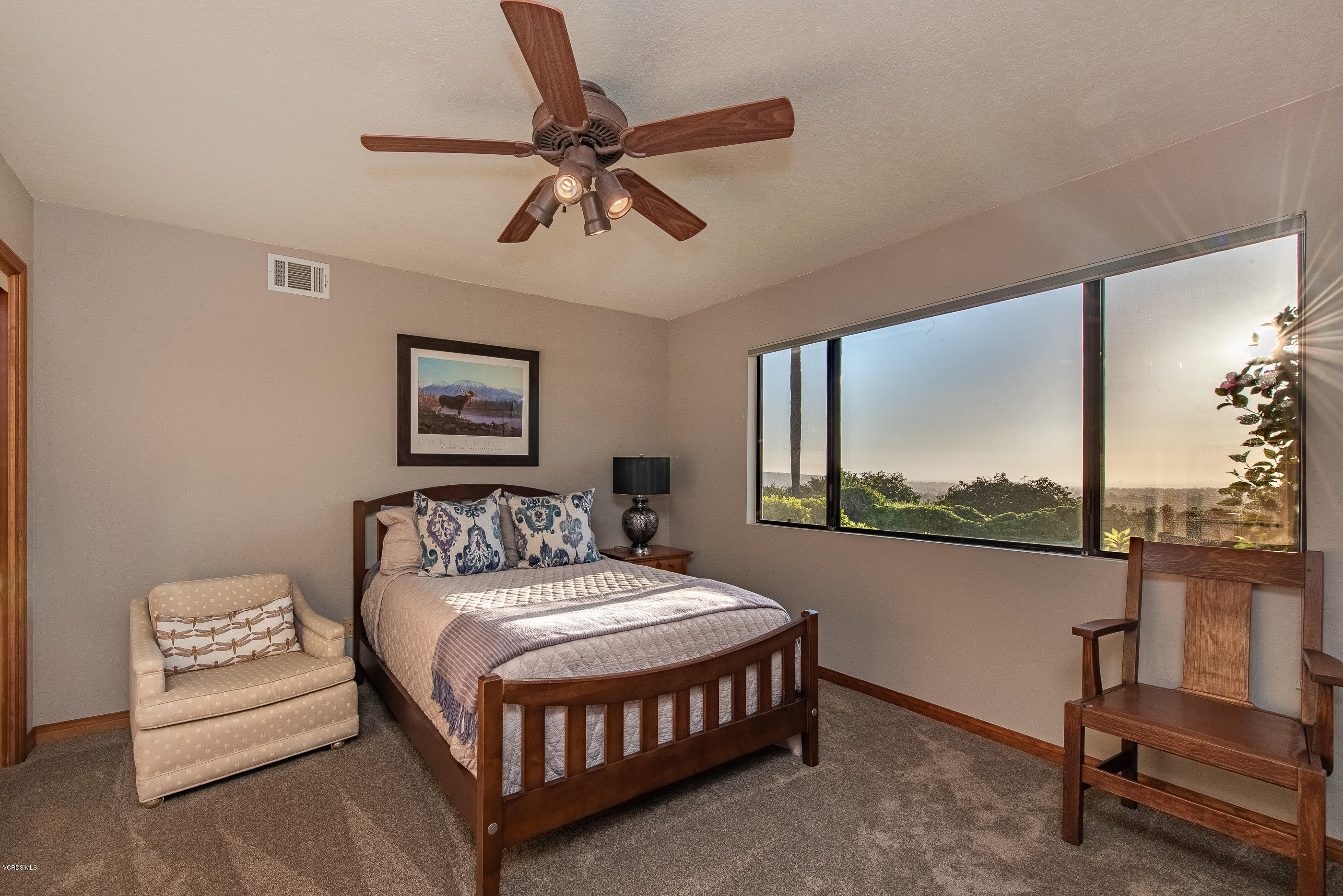 6138 West Greentree Drive Somis, CA 93066 - Photo 25 of 61 a bedroom with a bed a window and a flat screen tv