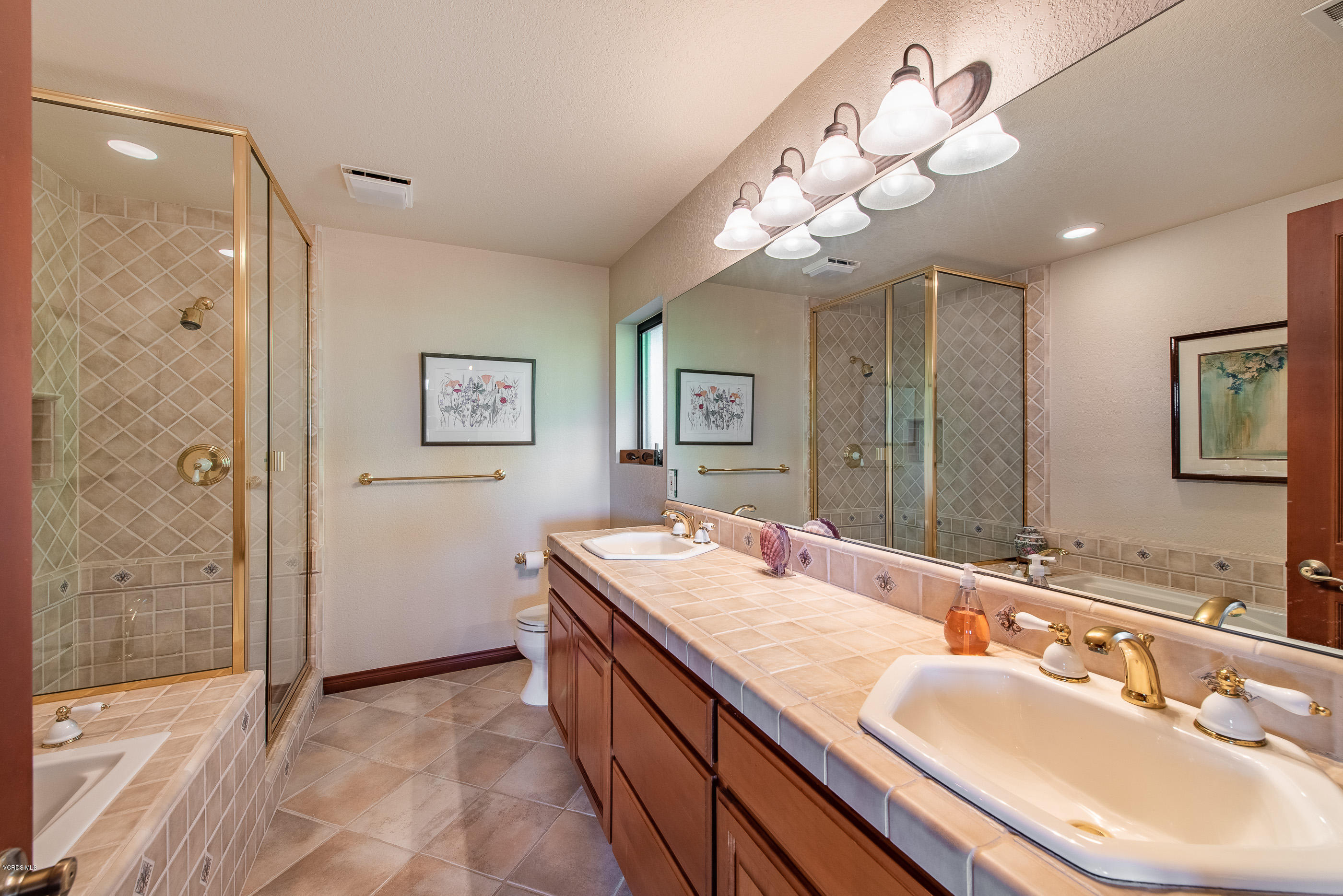 6138 West Greentree Drive Somis, CA 93066 - Photo 29 of 61 a bathroom with a granite countertop sink a large mirror and shower
