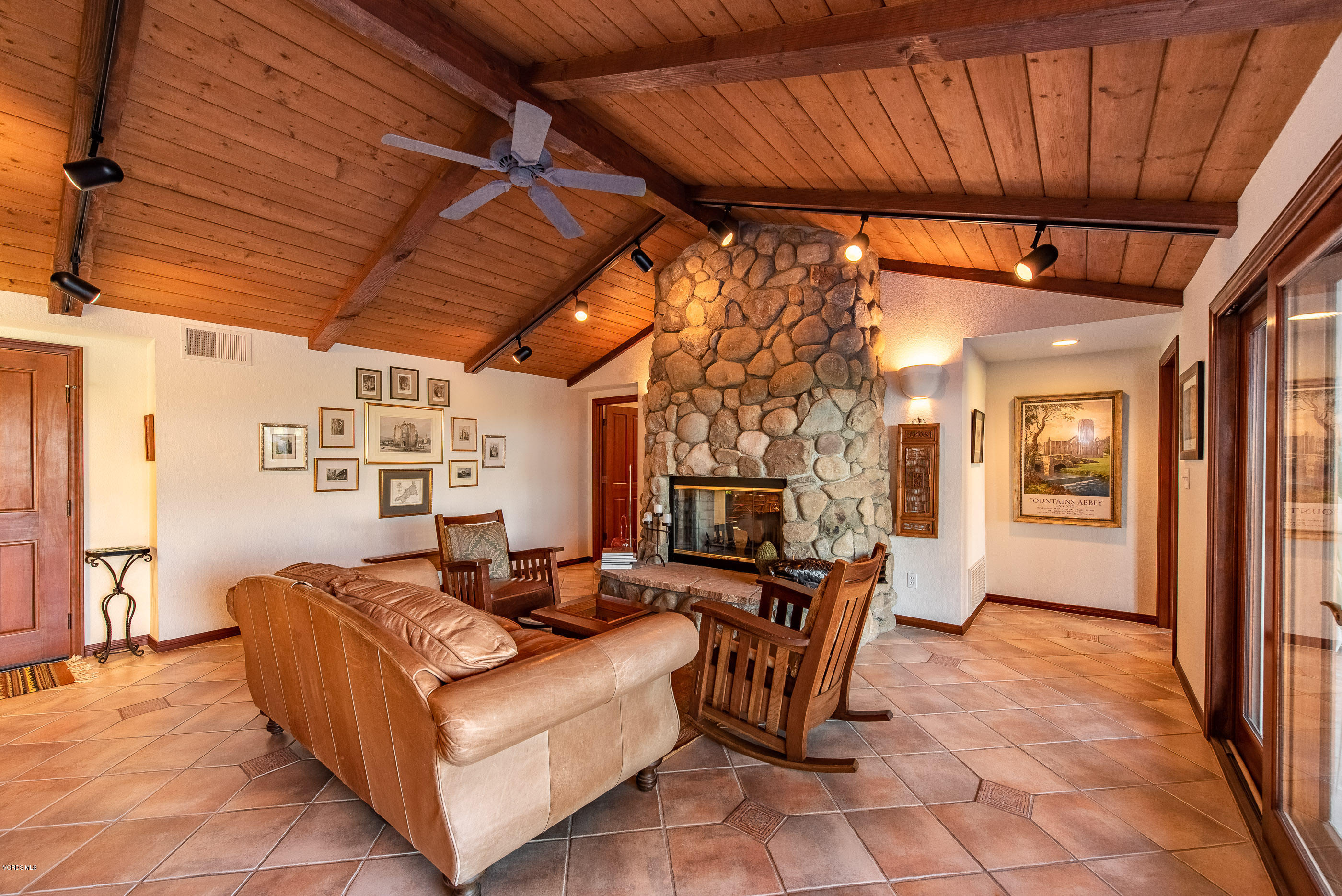 6138 West Greentree Drive Somis, CA 93066 - Photo 39 of 61 a living room with furniture a fireplace and a table