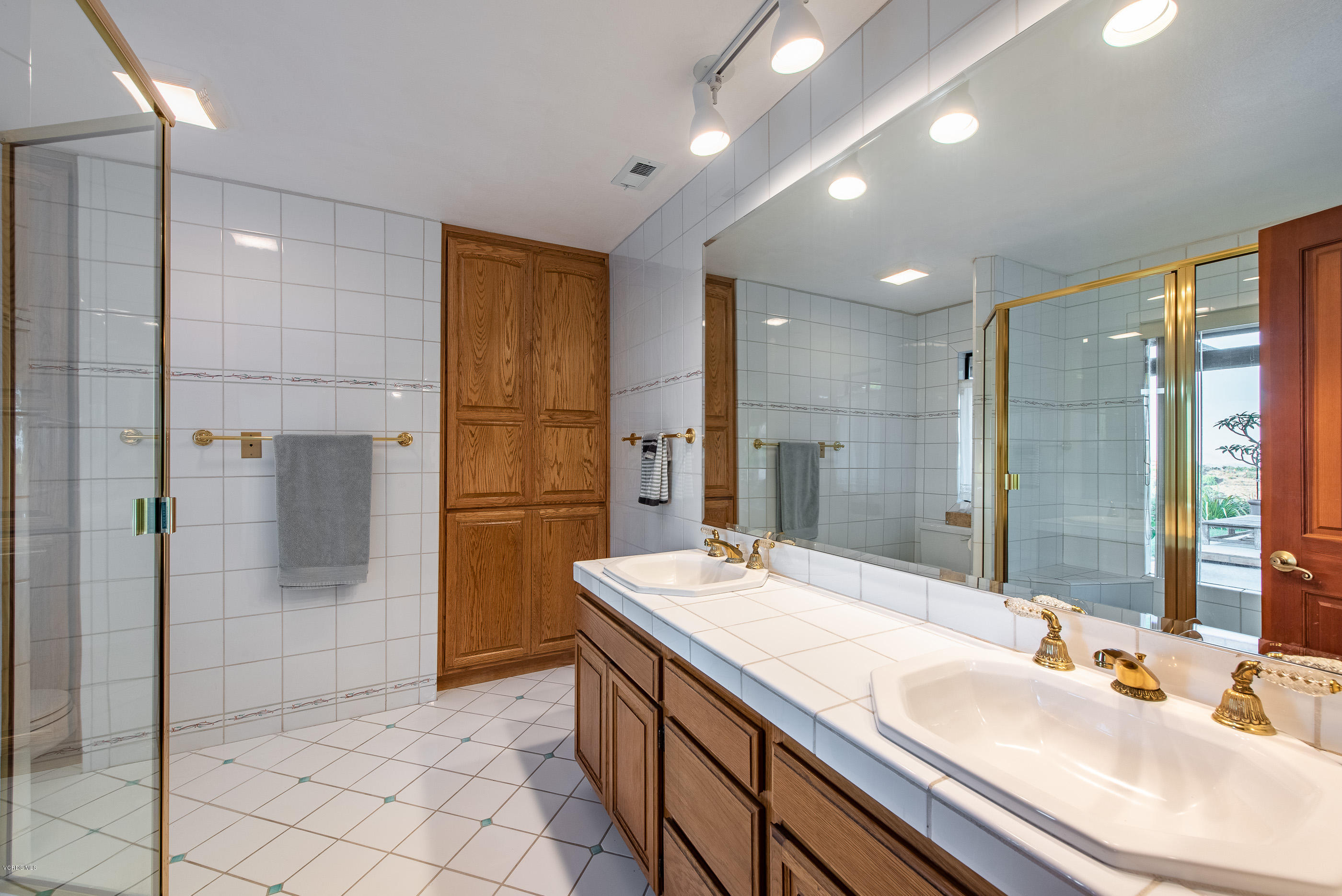 6138 West Greentree Drive Somis, CA 93066 - Photo 40 of 61 a bathroom with a granite countertop sink mirror and shower