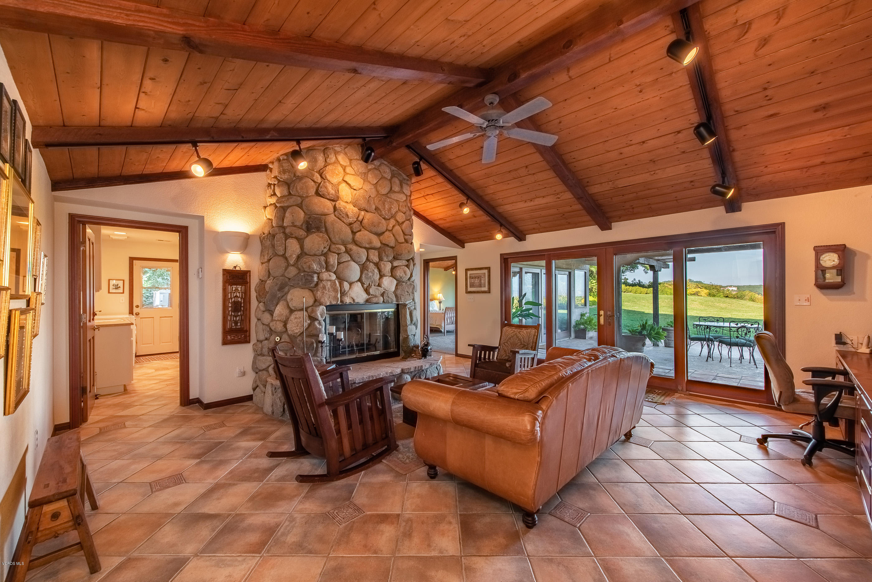 6138 West Greentree Drive Somis, CA 93066 - Photo 8 of 61 a living room with furniture a fireplace and a flat screen tv