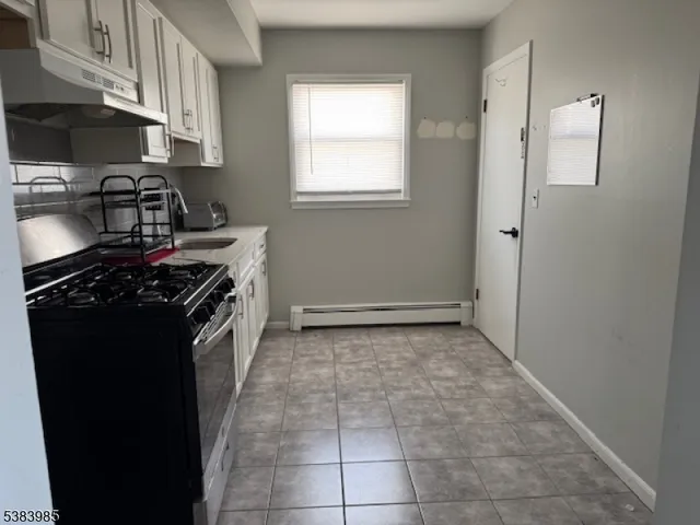 a kitchen with a stove and a refrigerator