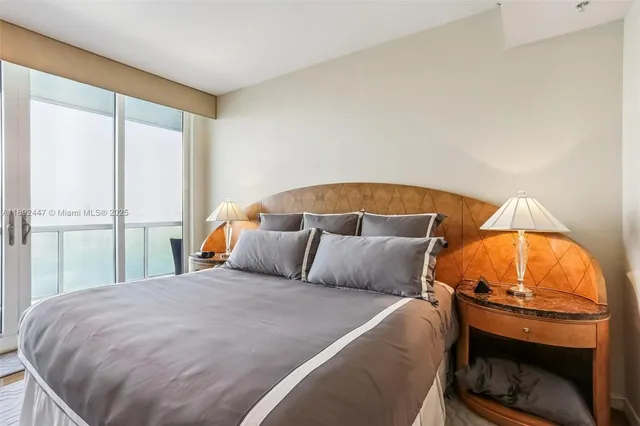 a living room with furniture a flat screen tv and a large window