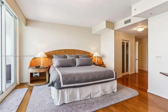 a bathroom with a tub shower sink and mirror