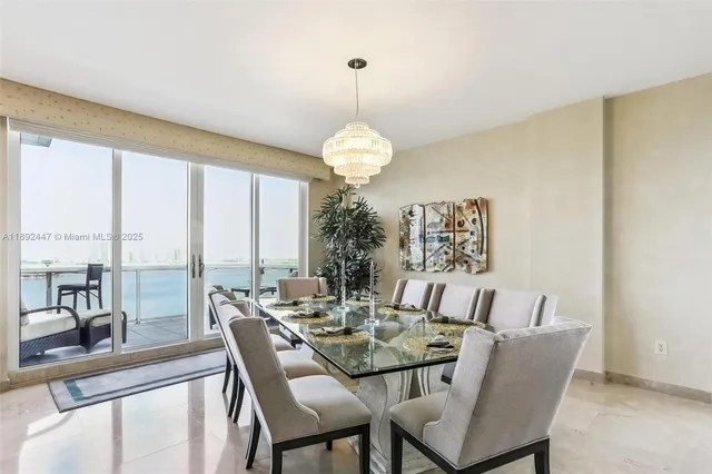 a kitchen with stainless steel appliances kitchen island granite countertop a refrigerator and cabinets