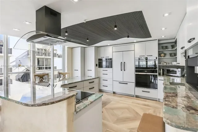 a kitchen with stainless steel appliances kitchen island granite countertop a sink and cabinets