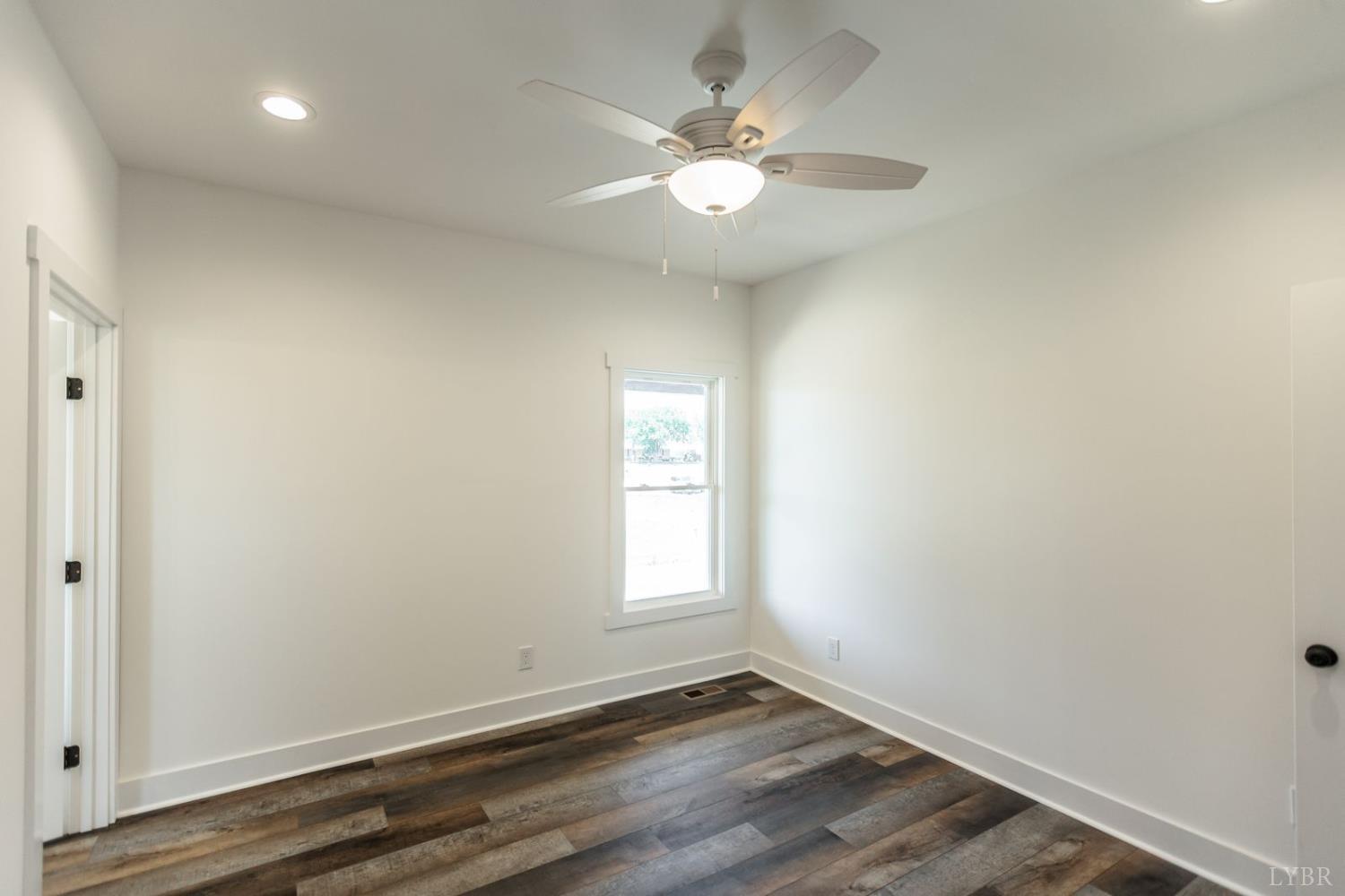 9740 Oakville Road Gladstone, VA 24553 - Photo 38 of 75 an empty room with wooden floor and windows
