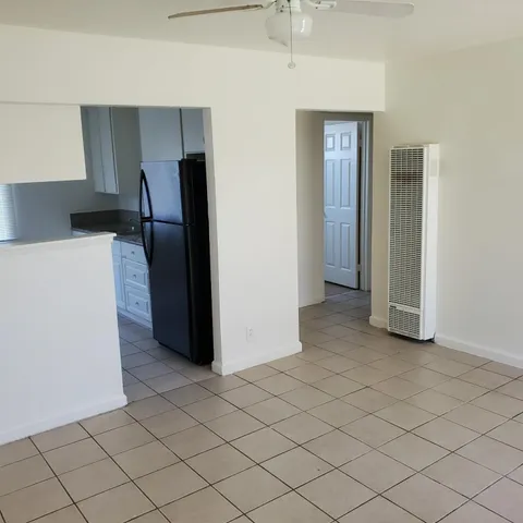 a kitchen with granite countertop white cabinets and a sink