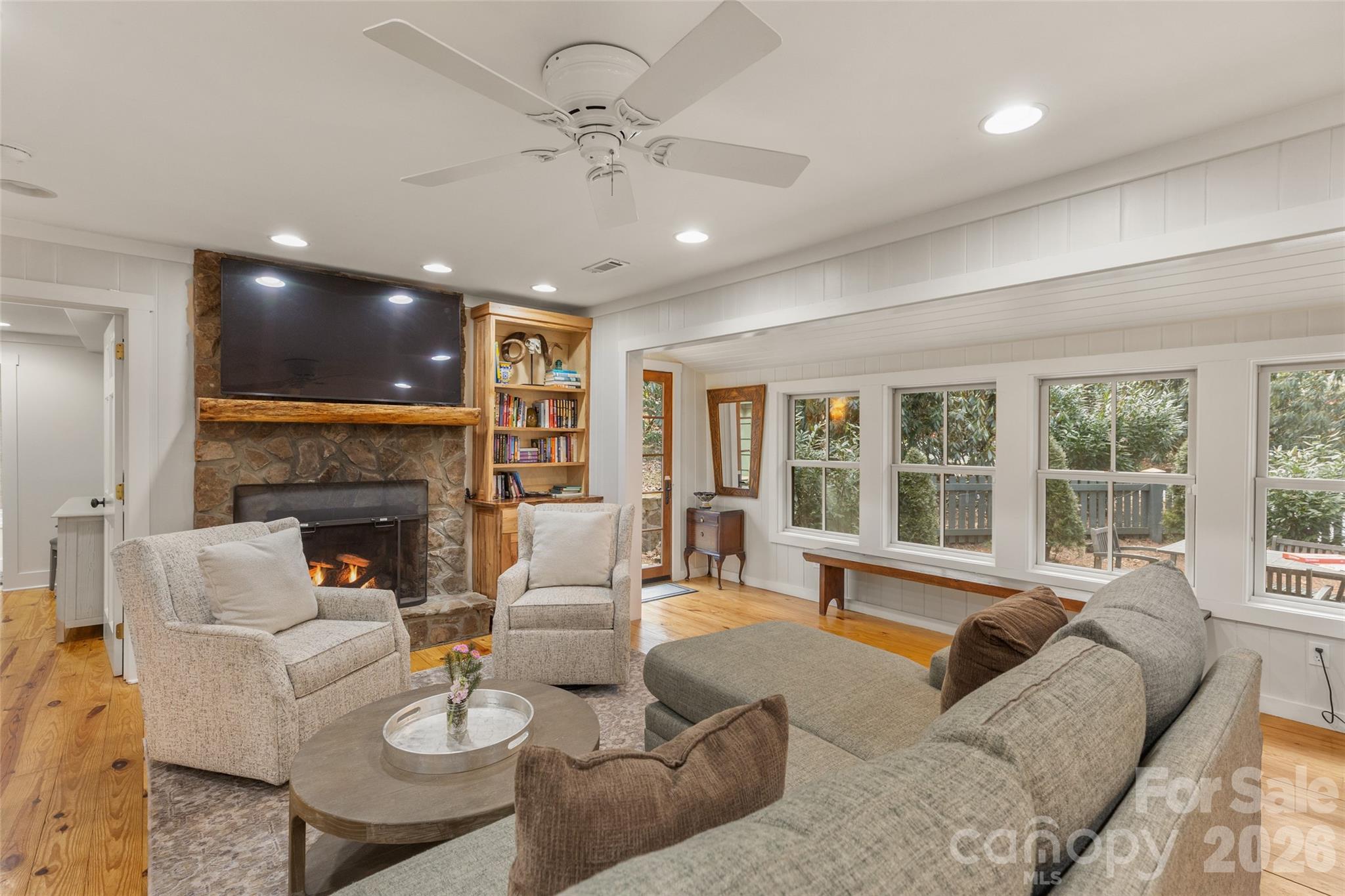 464 Franklin Road Highlands, NC 28741 - Photo 11 of 44 a living room with furniture a fireplace and a chandelier