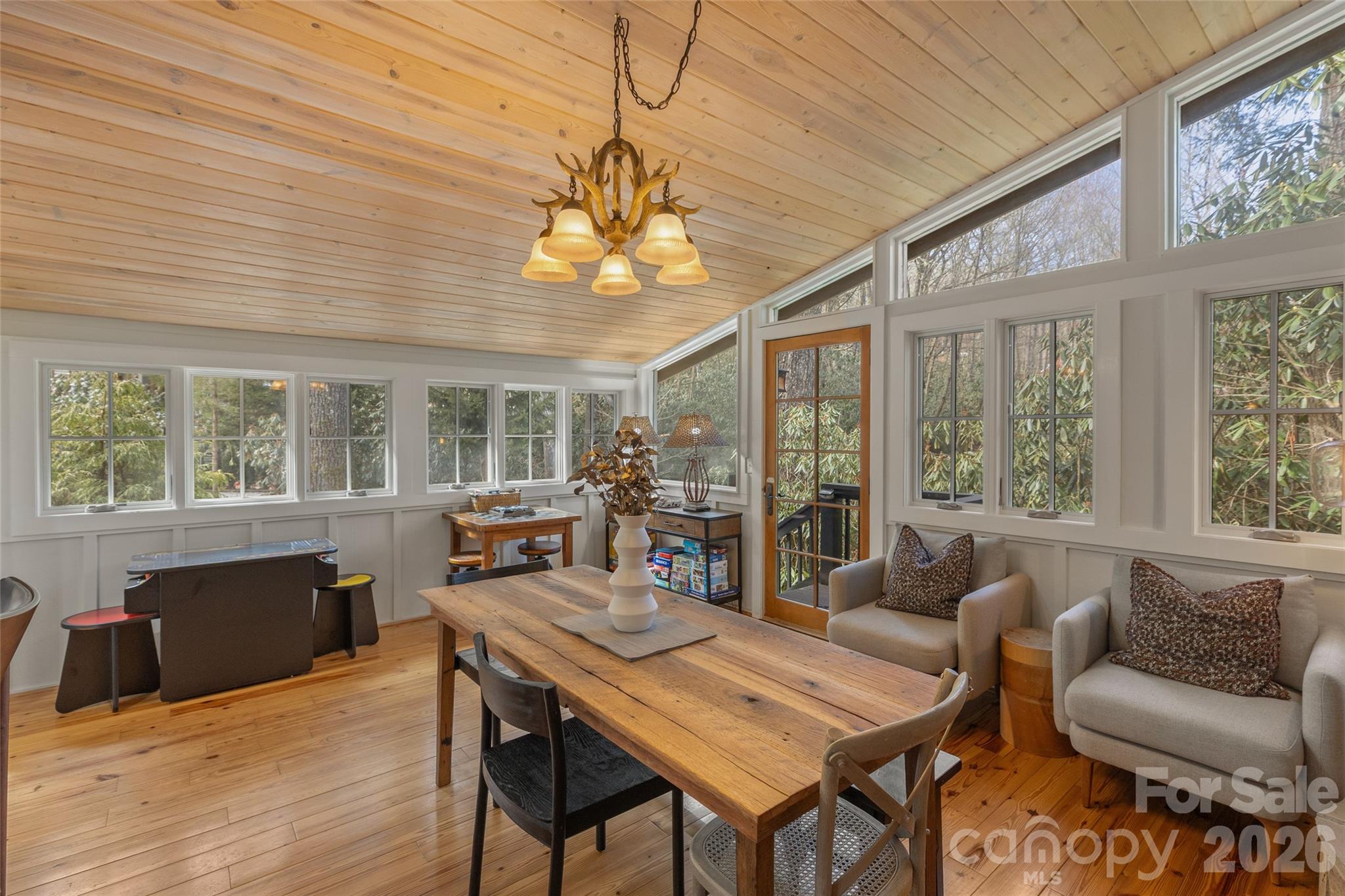 464 Franklin Road Highlands, NC 28741 - Photo 27 of 44 a view of a dining room with furniture large windows and wooden floor