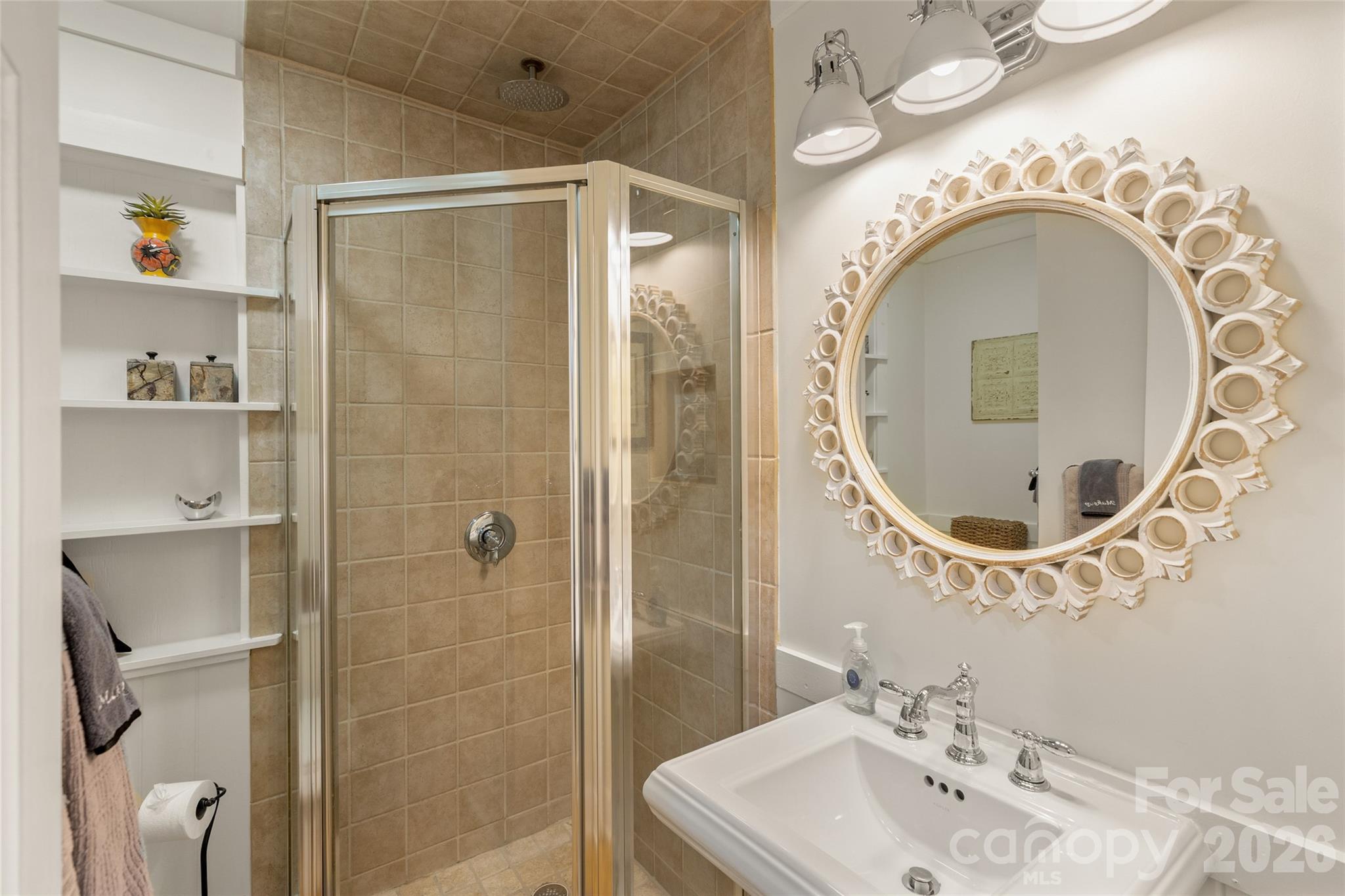 464 Franklin Road Highlands, NC 28741 - Photo 36 of 44 a bathroom with a sink a mirror and shower