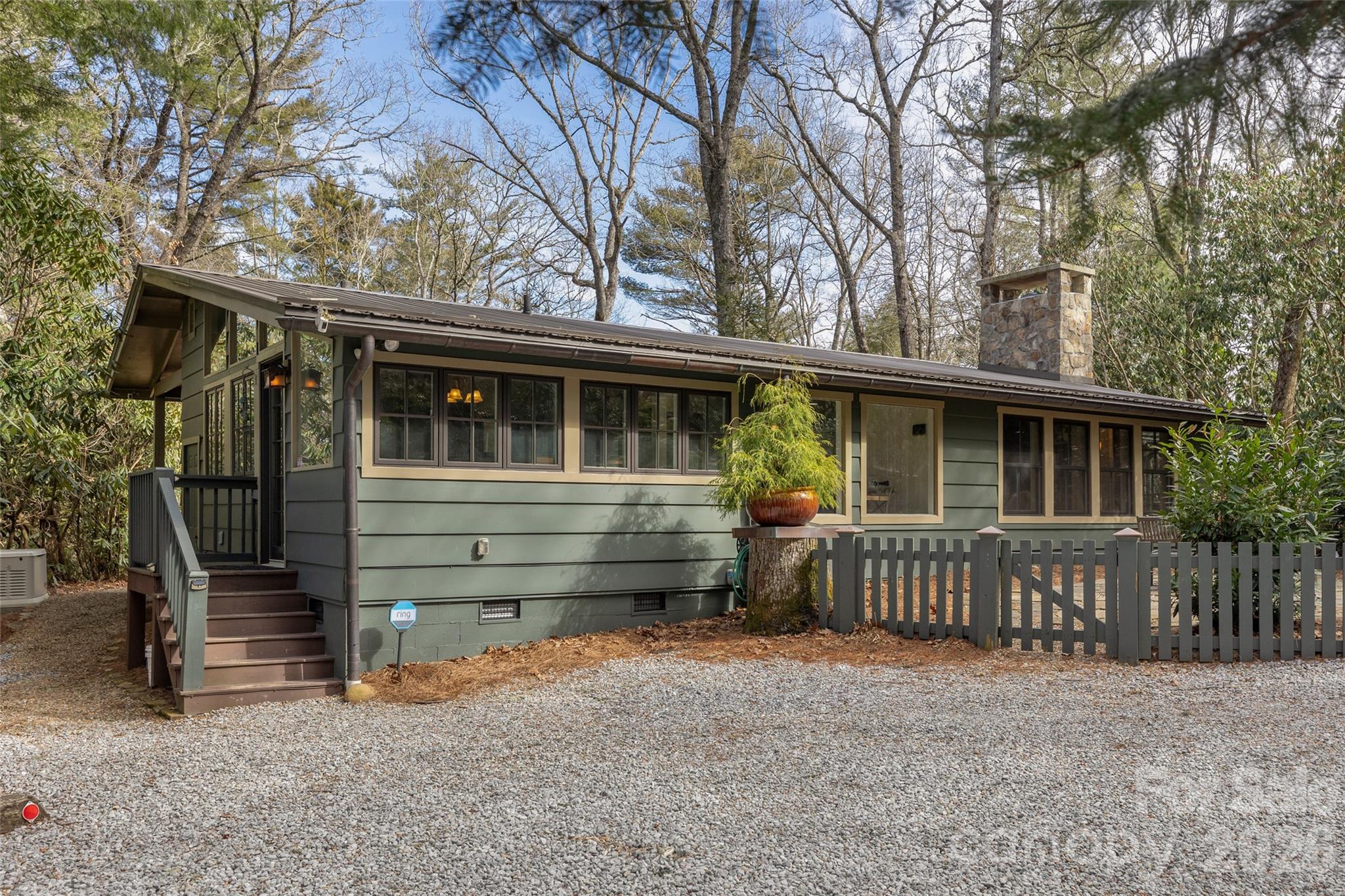 464 Franklin Road Highlands, NC 28741 - Photo 4 of 44 a front view of a house with a fence