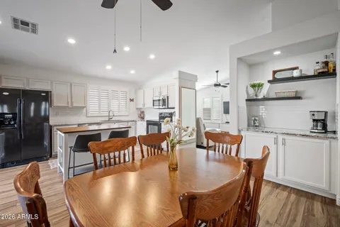 a dining room with furniture and wooden floor