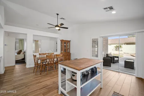 a kitchen with a wooden table and chairs