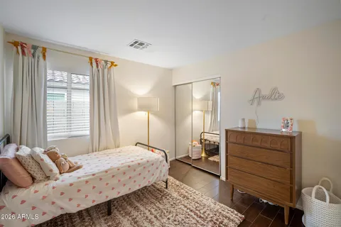 a bedroom with a bed and wooden floor