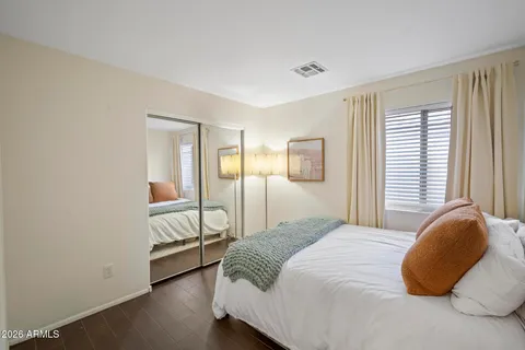 a bedroom with a bed and a potted plant