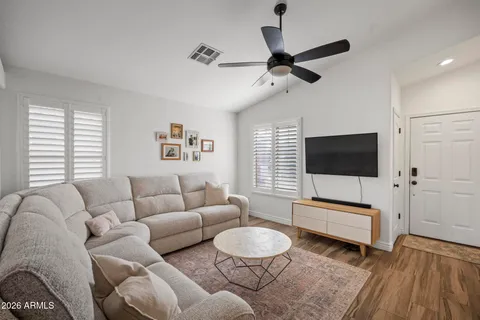 a living room with furniture and a flat screen tv