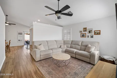 a living room with furniture and a wooden floor