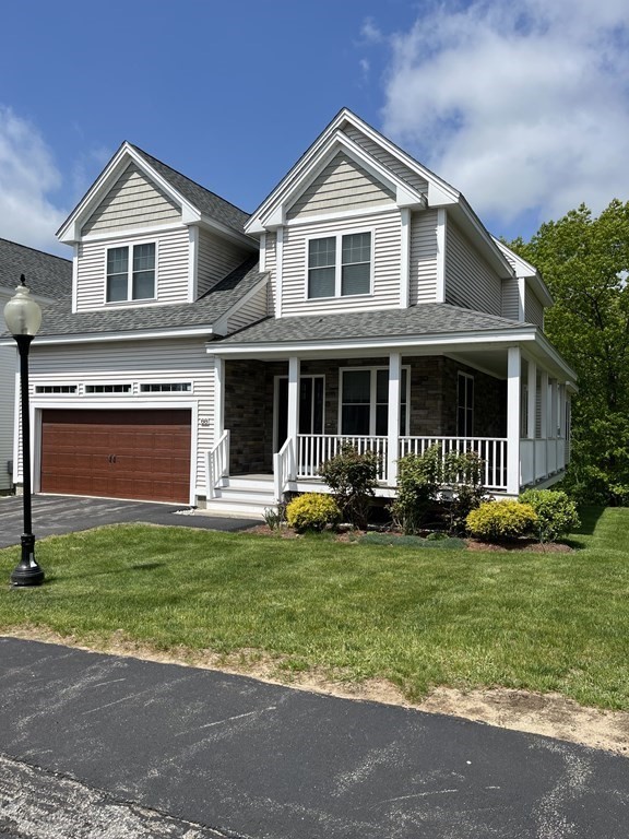 a front view of a house with a garden and porch