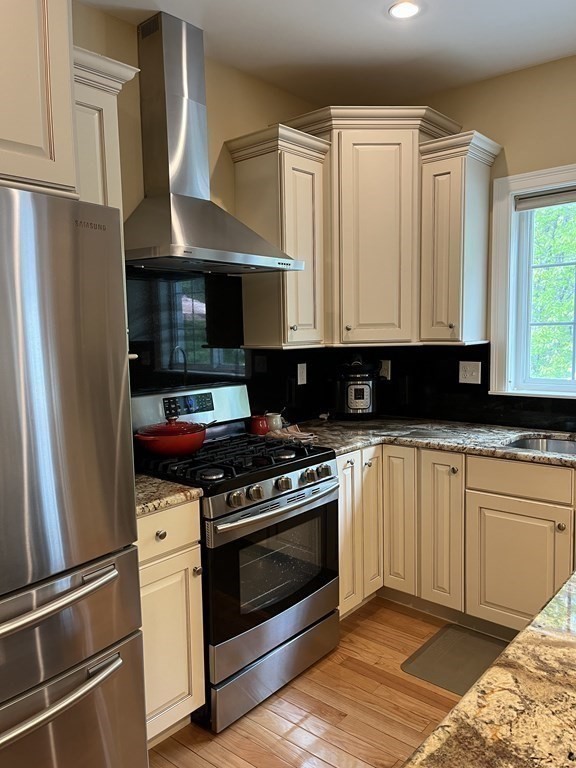 88 Indian Ridge Terrace, Unit 88 Westford, MA 01886 - Photo 13 of 39 a kitchen with granite countertop a stove and a refrigerator