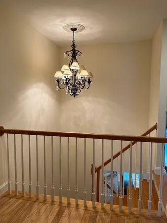 a view of a chandelier and wooden floor