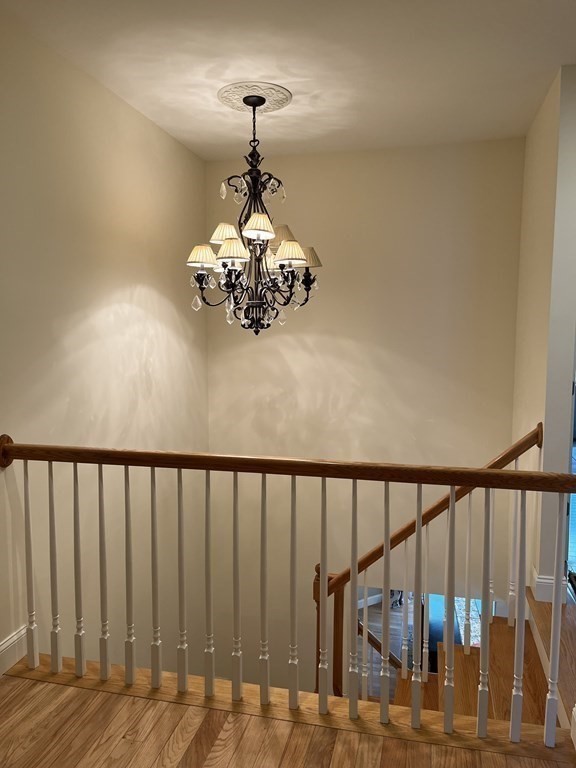 88 Indian Ridge Terrace, Unit 88 Westford, MA 01886 - Photo 16 of 39 a view of a chandelier and wooden floor