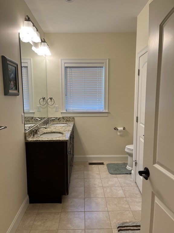 88 Indian Ridge Terrace, Unit 88 Westford, MA 01886 - Photo 18 of 39 a bathroom with a sink vanity and toilet