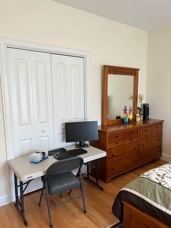 a bed sitting in a room next to a lamp