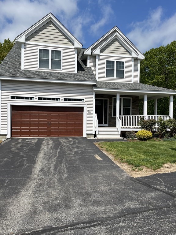 88 Indian Ridge Terrace, Unit 88 Westford, MA 01886 - Photo 2 of 39 a front view of a house with a yard and garage