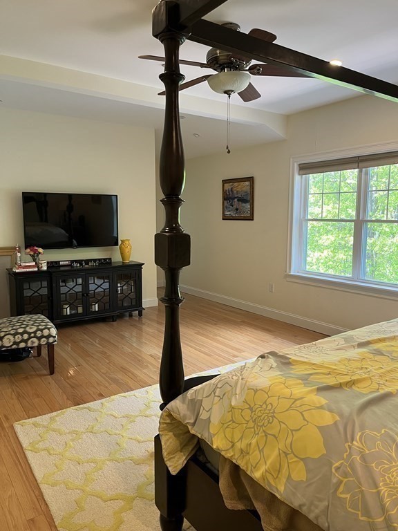 88 Indian Ridge Terrace, Unit 88 Westford, MA 01886 - Photo 22 of 39 a bed room with a bed and a flat screen tv