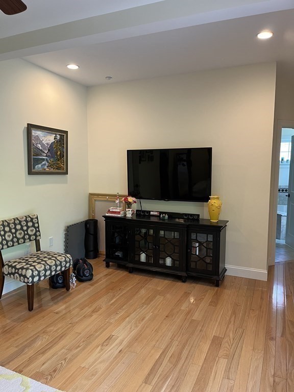 88 Indian Ridge Terrace, Unit 88 Westford, MA 01886 - Photo 23 of 39 a living room with furniture and a flat screen tv